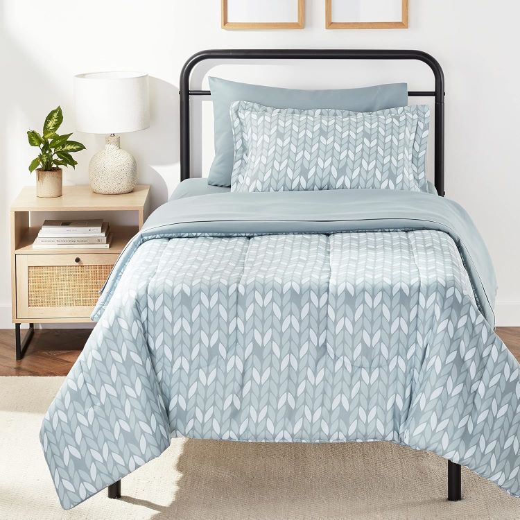 Photo Of Twin Sized Bed With Blue Geometric Bedspread