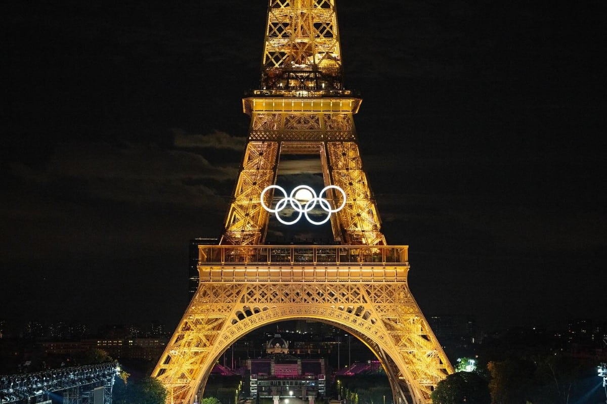 Full moon inside Olympic Rings hung on the Eiffel Tower