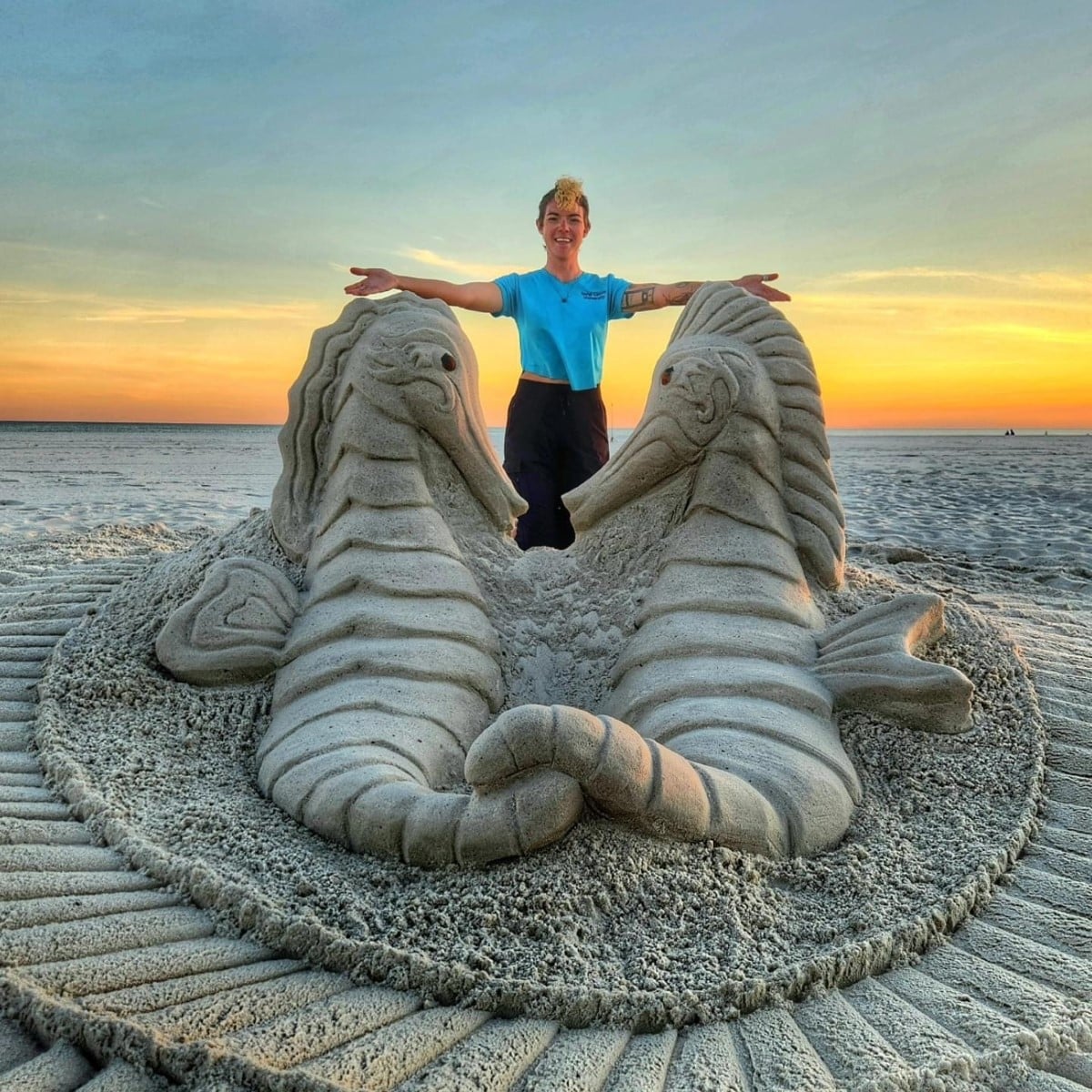 Janel Hawkins and sea horse sand sculpture