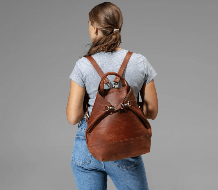 Woman With Leather Backpack On Her Back