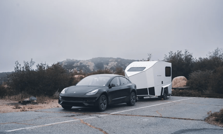 Black Sedan With Camper Trailer Behind It