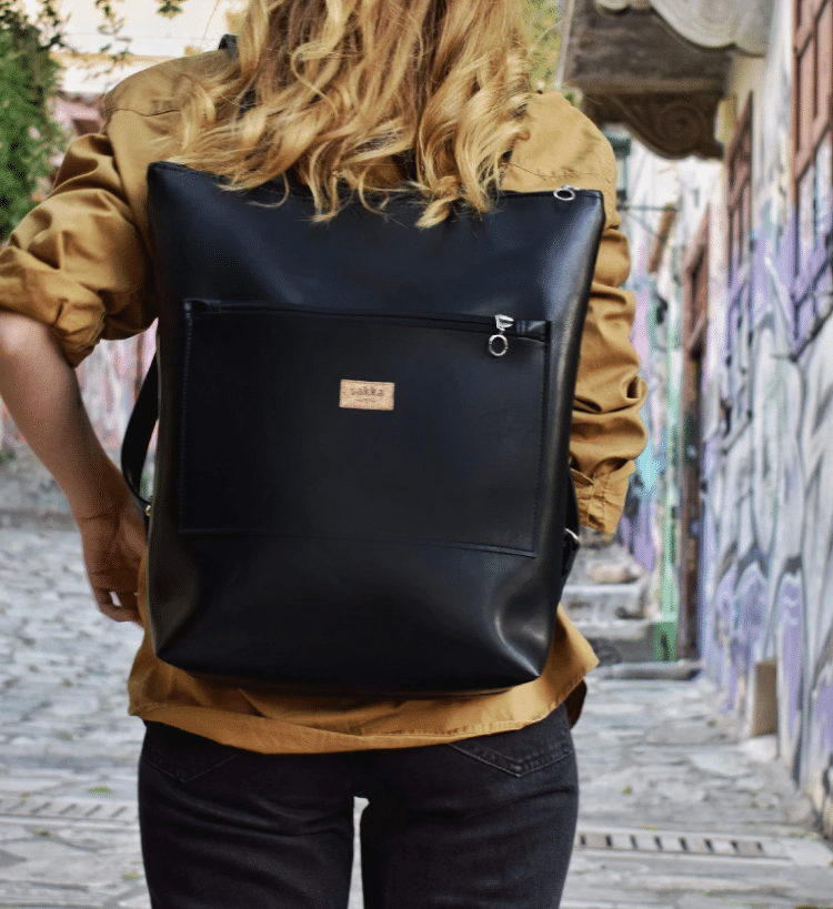 Person Walking Through Street With Black Leather Backpack